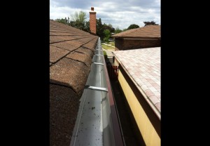 gutter slope and alignment inspection along roof edge