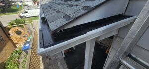 Gutter guard installed at roof edge on residential home