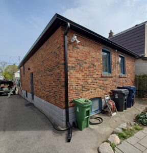 downspout repair along side wall of home in Brampton