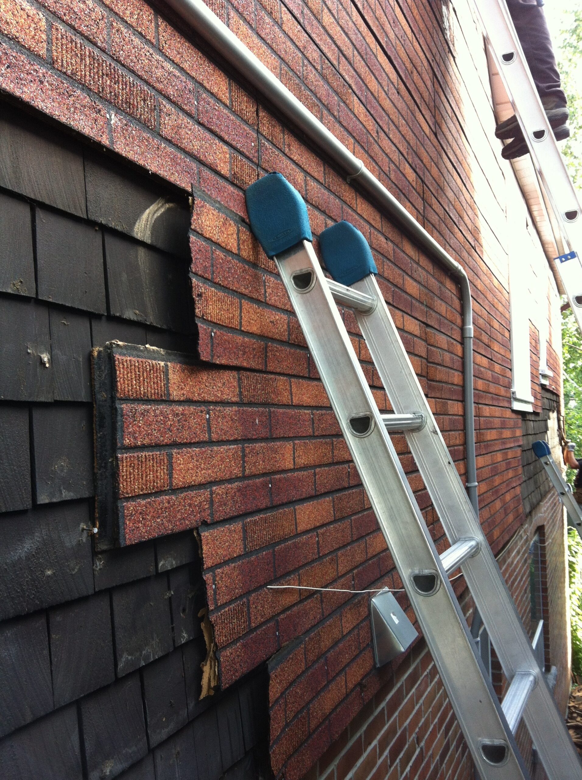 siding repair fixing damaged exterior panels on house