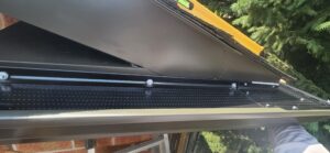 Close-up of aluminum gutter guard attached to eavestrough