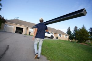 men working carrying eavestrough
