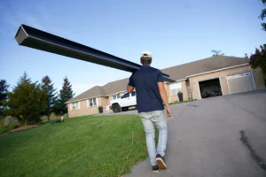 men working carrying eavestrough