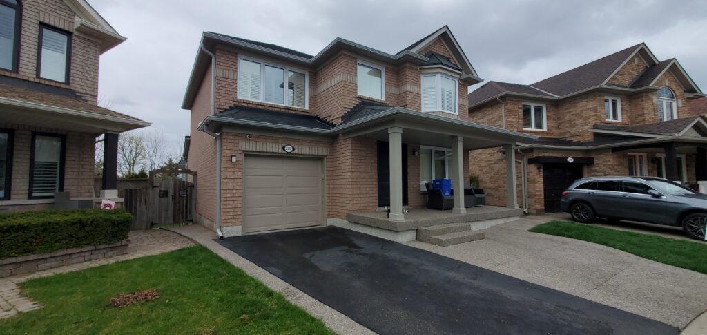 New aluminum seamless eavestrough system installed on a home exterior.