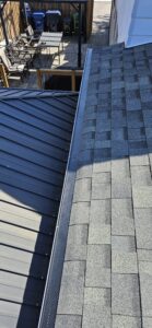 Gutter guard installed near tree-lined roof area