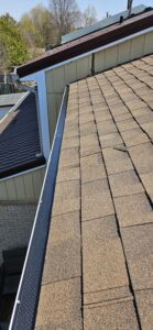 Long section gutter guard installation along roofline