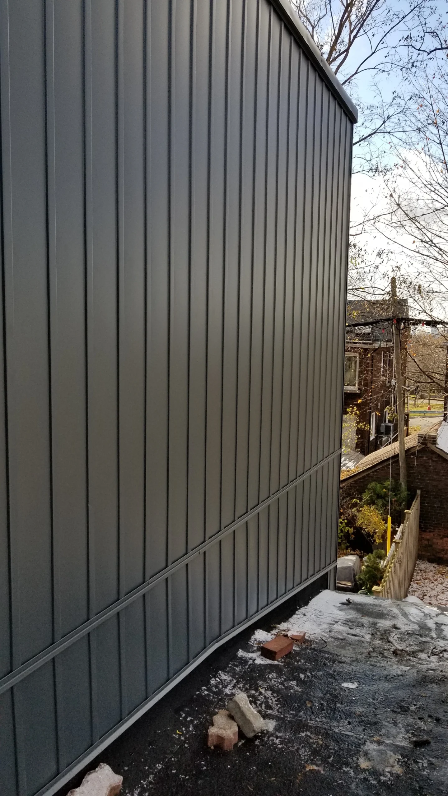 Close up of vertical aluminum siding installed on a home in Toronto, highlighting modern, clean lines.