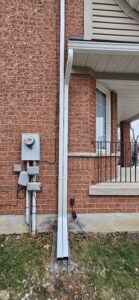 downspout repair along exterior wall in North York